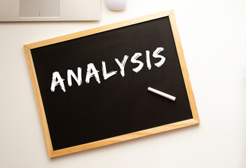 The text is written in chalk on a slate board. business concept