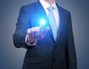 Businessman in suit touching virtual button