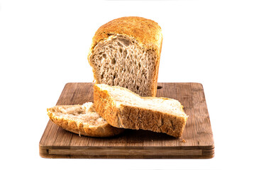 Sliced loaf of wheat bread on a cutting board.