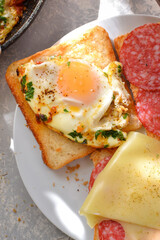 Tasty breakfast. Toast with egg, cheese and sausage. Vertical view. View from above. Three toasts