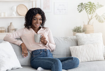 Coffee Time. Beautiful Black Woman Enjoying Cup Of Hot Drink At Home