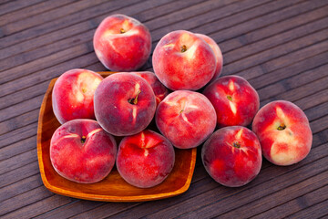 Fototapeta na wymiar Fresh juicy peaches on wooden background, harvest season