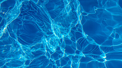 The water in the pool is blue, penetrated by the rays of the sun. Selective focus. Healthy...