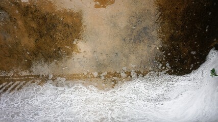 Background of foam bubbles on cement floor that can create a variety of stories