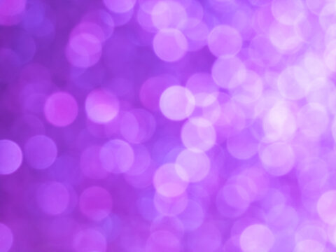 Abstract colorful white light to purple bokeh gradient effect texture on black background. glitter modern lights defocused look luxury and elegant for celebrating or cosmetic products.