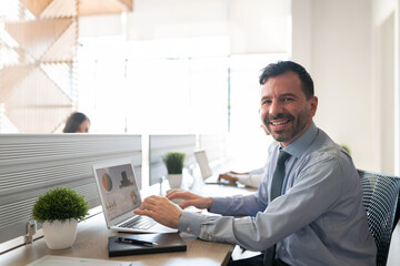 Smiling businessman working at his office desk