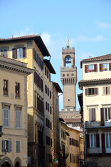 Fototapeta na wymiar The historic buildings of Piazza Santa Croce in Florence and in the background the tower of Arnolfo overlooking Palazzo Vecchio in Piazza della Signoria.