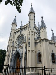 Fototapeta na wymiar Beautiful grey Gothic chapel in the Park 