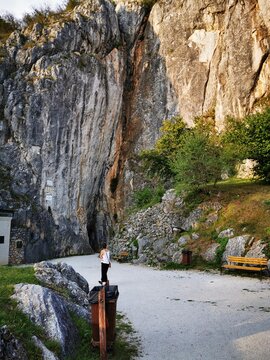 The huge Aggtelek karst, and the entrance to the stalactite cave, and the walking young girl
