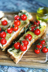 Selective focus. Delicious bruschetta with olive oil and cherry tomatoes. Italian Cuisine
