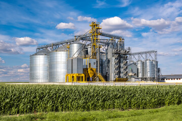 Modern Granary elevator. Silver silos on agro-processing and manufacturing plant for processing...