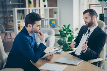 Portrait of two nice attractive handsome classy imposing trendy men economist financier agent broker signing contract hr management in light white interior work place station