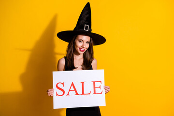 Portrait of her she nice attractive pretty lovely cheerful cheery lady holding in hands promo card saying sale word bargain time isolated over bright vivid shine vibrant yellow color background