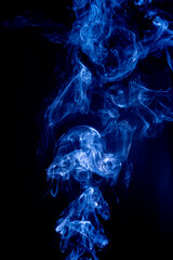 Blue abstract shaped smoke against black background. Abstract background