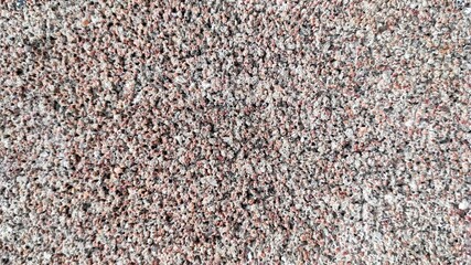 Building material from multi-colored grains of crushed stone for finishing work on external surfaces