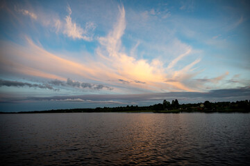 sunrise over the lake when the sky is covered with rain clouds