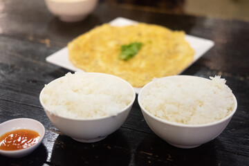 Two bowl of Jasmine rice and omelette