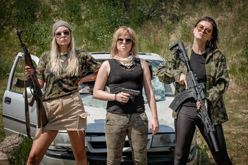 Military team of three attractive female soldier with guns, rifle machine gun and sniper. Woman with weapon. Fashion model style
