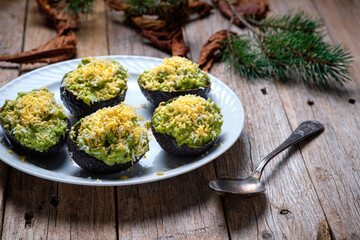 Avocados stuffed with tuna on rustic background