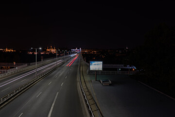 light from street lights and reflections of lights on the road in the center of the old town of Prague at night in the Czech Republic