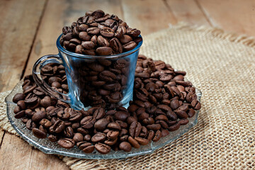 blue cup with coffee beans on a rustic wooden table with copy for text 
