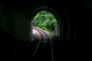 Image taken from vista-dome tourist coach of a tunnel portal with railway line.