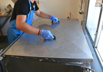 Cheesemaker closing the tank while heating the milk.