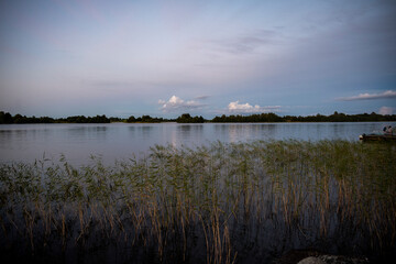 sunrise over the lake when the sky is covered with rain clouds