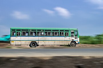 Fototapeta na wymiar Motion blur image of non air-conditioned intercity bus in Maharashtra.