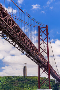Ponte 25 de Abril Bridge with Cristo Rei statue (Christ the King Sanctuary) behind, suspension bridge over the Tagus River, Lisbon, Portugal