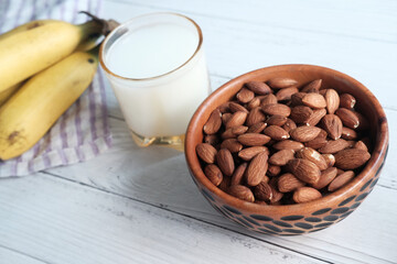 top view of almond, milk and banana on table.
