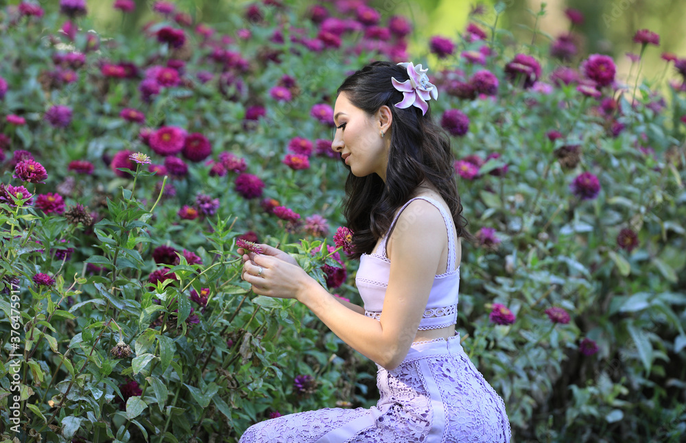 Wall mural portrait of a girl in a flower garden