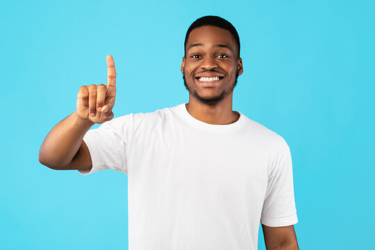 Smiling Black Guy Showing Number One With Finger, Studio Shot