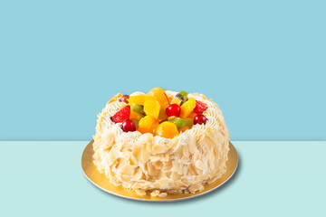 Fruit cake with almonds cream isolated on blue background.