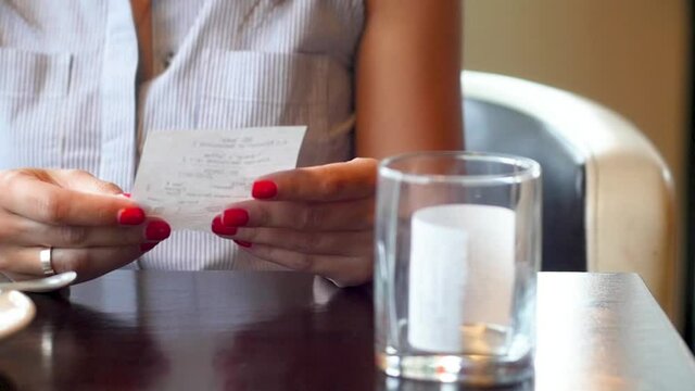 NFC technology. Close-up of young woman using credit card with NFC chip on bank terminal. Customer paying for food order outdoor. Detail of a client hands paying with the contactless credit card.