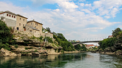 Fototapeta premium The green Neretva River underneath the old bridge in Mostar, Bosnia