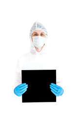 a man in a protective suit, gloves and face mask holds a sign in his hands. Isolated on a white background