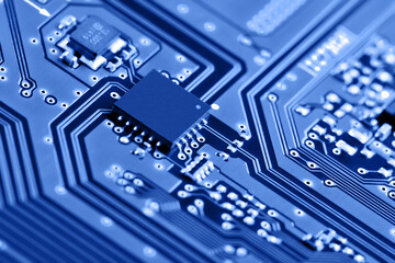 Electronic circuit board close up. Blue background.