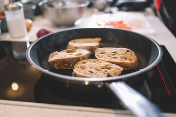 Croutons fried in a pan on the induction cooker.