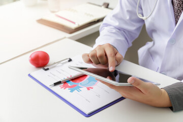 Doctor working with tablet computer at desk. Technology and medical concept.