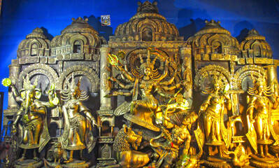 Fototapeta na wymiar Durga Puja or Durgotsava,is an annual Hindu festival celebrated mainly in West Bengal,Indian.Durga is Goddess riding a lion with many arms each carrying weapon and defeating evil power of Mahishasura.