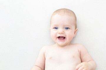 Cute baby girl lying on bed