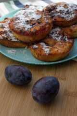 ripe fruit and plums and a plate of cheesecakes