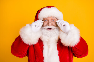 Portrait astonished santa claus impressed x-mas newyear christmas magic miracle advent sales discount touch white gloves specs wear red headwear isolated bright shine color background