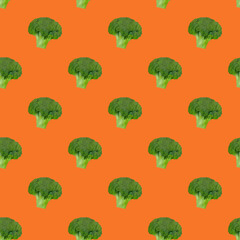 Broccoli cabbage pattern on orange background. Healthy eating. Vegetarianism.