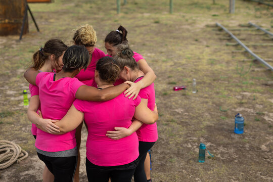 Group of woman forming a huddle at boot camp - Powered by Adobe