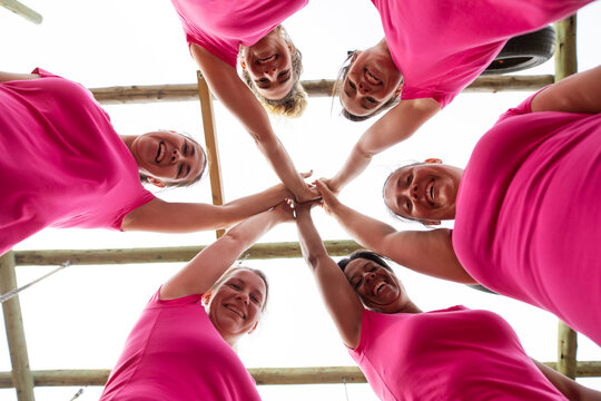 Group of woman high fiving each other at boot camp