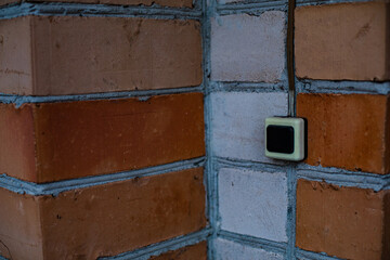 Picture a wall of white and red brick. Brick wall with doorbell