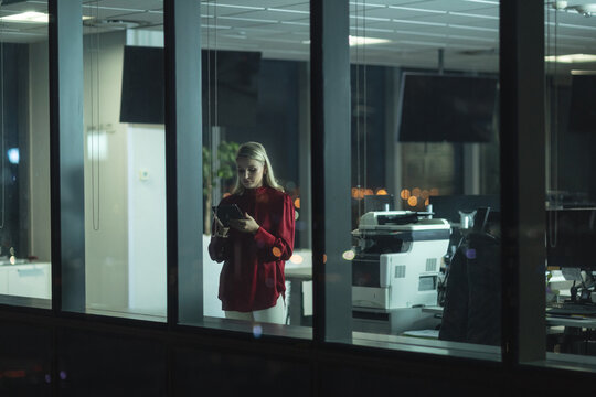 Young businesswoman using digital tablet at modern office