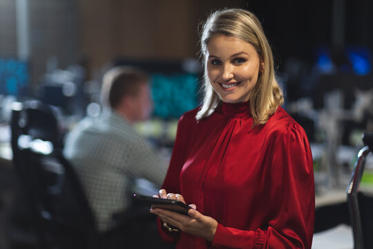 Portrait of young businesswoman using digital tablet at modern office